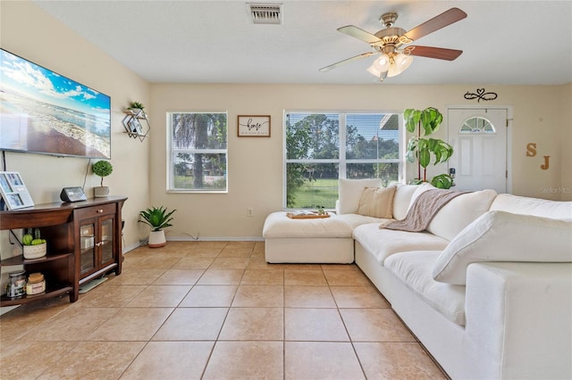 tiled living room featuring ceiling fan