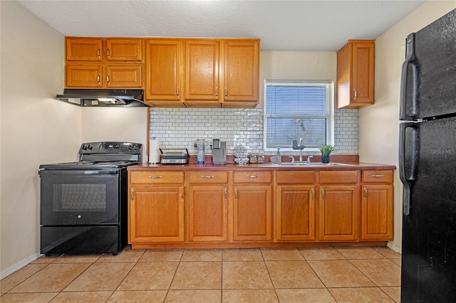 kitchen featuring decorative backsplash, sink, light tile patterned flooring, and black appliances