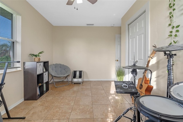 interior space with tile patterned flooring and ceiling fan