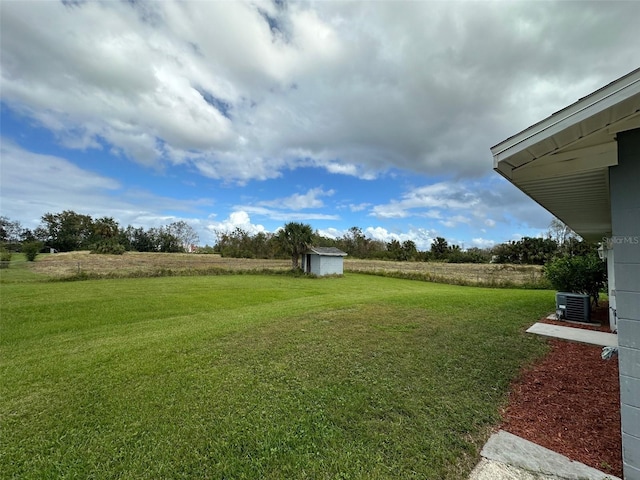 view of yard with a storage shed and cooling unit