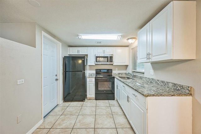 10226 Willow Dr, Port Richey, FL 34668 - kitchen with light stone countertops, white cabinets, black appliances, light tile patterned flooring, and a sink