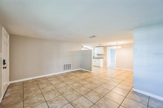 10226 Willow Dr, Port Richey, FL 34668 - spare room with visible vents, baseboards, a chandelier, and light tile patterned floors