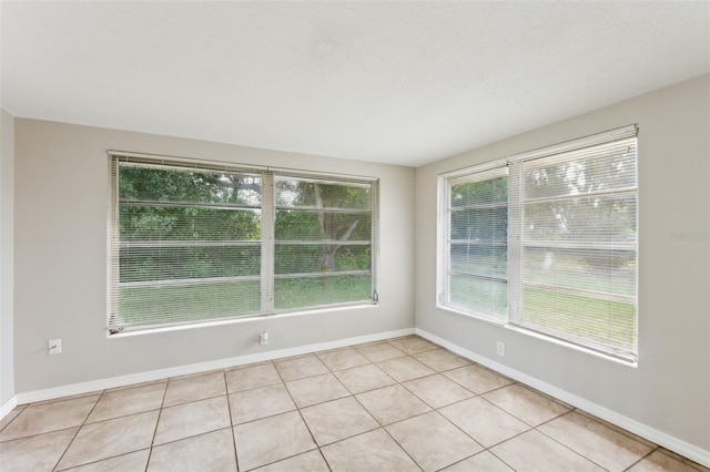 10226 Willow Dr, Port Richey, FL 34668 - spare room featuring light tile patterned floors and baseboards