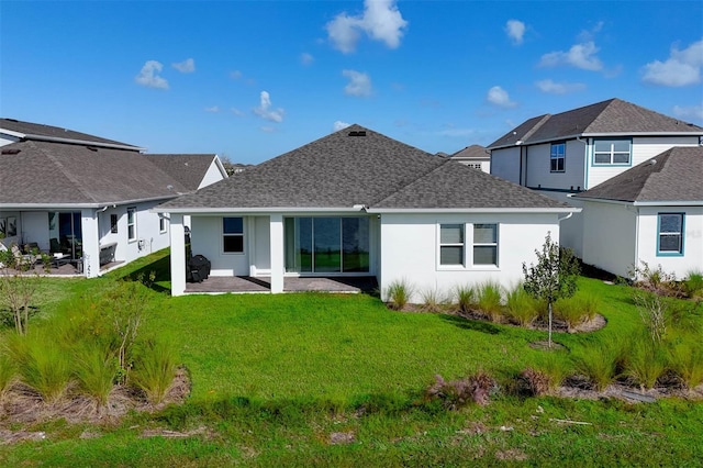 rear view of house with a yard and a patio