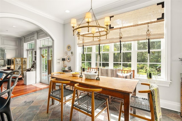 dining area featuring an inviting chandelier, dark hardwood / wood-style floors, plenty of natural light, and crown molding