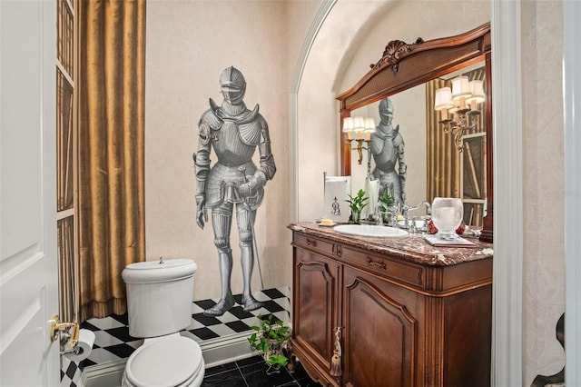 bathroom featuring tile patterned flooring, walk in shower, vanity, and toilet