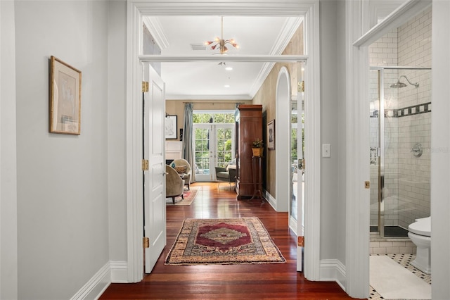 entrance foyer featuring french doors, dark hardwood / wood-style floors, and ornamental molding