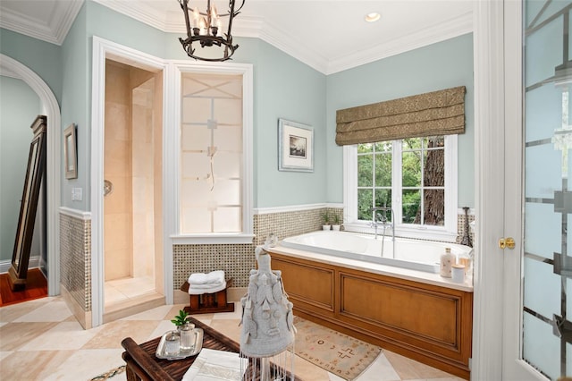 bathroom featuring ornamental molding, tile walls, a notable chandelier, and separate shower and tub