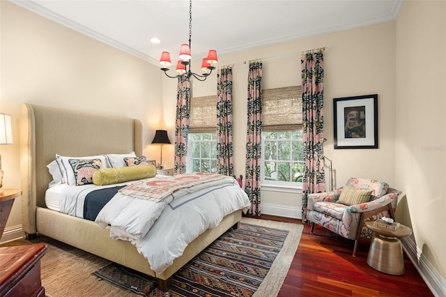 bedroom with ornamental molding, dark wood-type flooring, and a chandelier