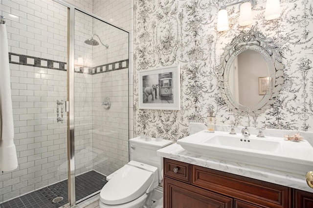 bathroom with an enclosed shower, vanity, and toilet