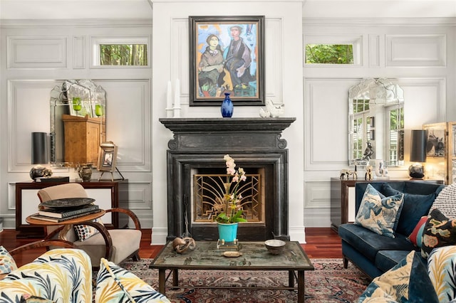 sitting room featuring wood-type flooring and ornamental molding