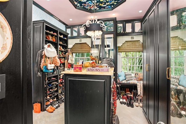 interior space featuring plenty of natural light, hanging light fixtures, and crown molding