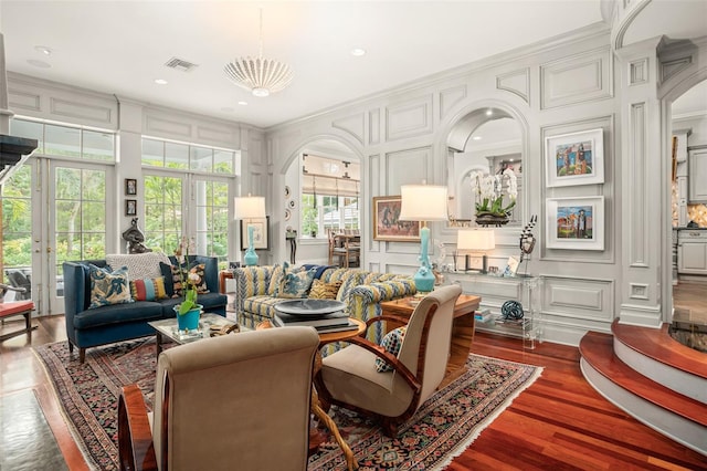 living room with crown molding, french doors, and dark hardwood / wood-style flooring