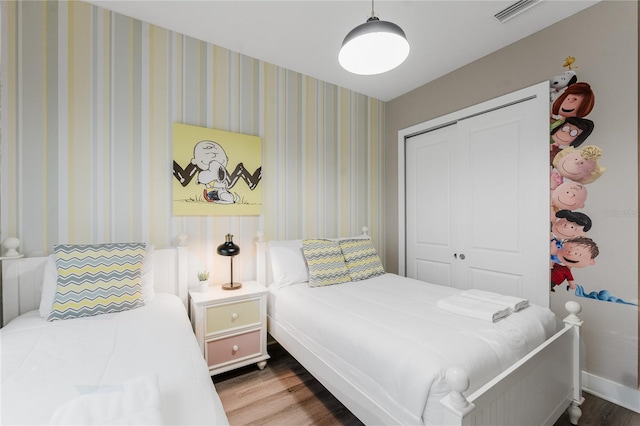 bedroom featuring hardwood / wood-style floors and a closet