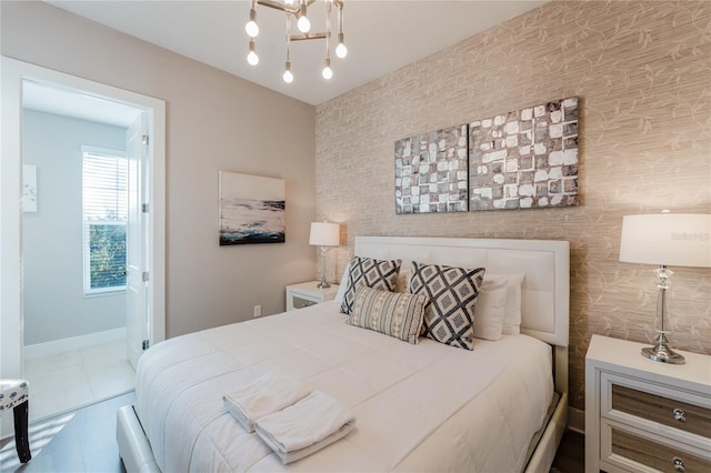 tiled bedroom featuring an inviting chandelier