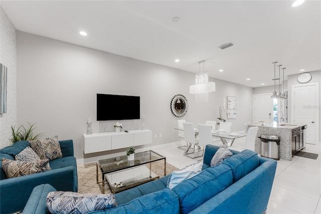 living room featuring sink and light tile patterned floors