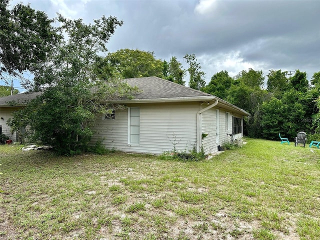 view of side of property featuring a yard