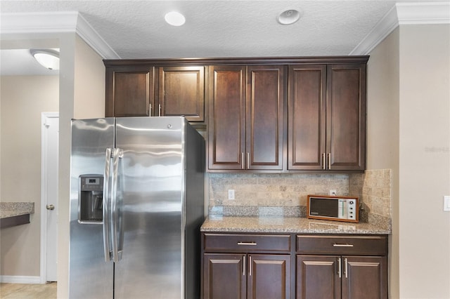 kitchen with decorative backsplash, dark brown cabinetry, stainless steel fridge with ice dispenser, and crown molding