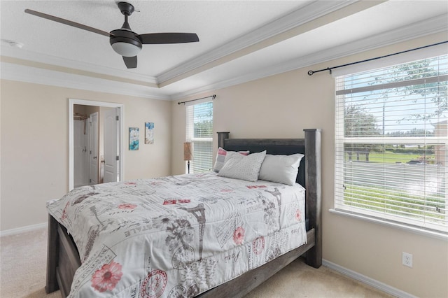 bedroom featuring ornamental molding, multiple windows, light colored carpet, and ceiling fan