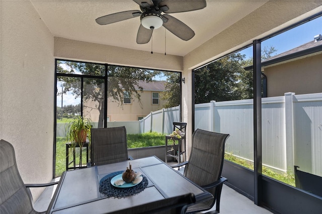 sunroom featuring ceiling fan