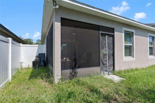 view of side of property featuring a sunroom