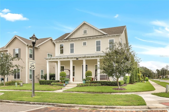 view of front of home with covered porch and a front yard