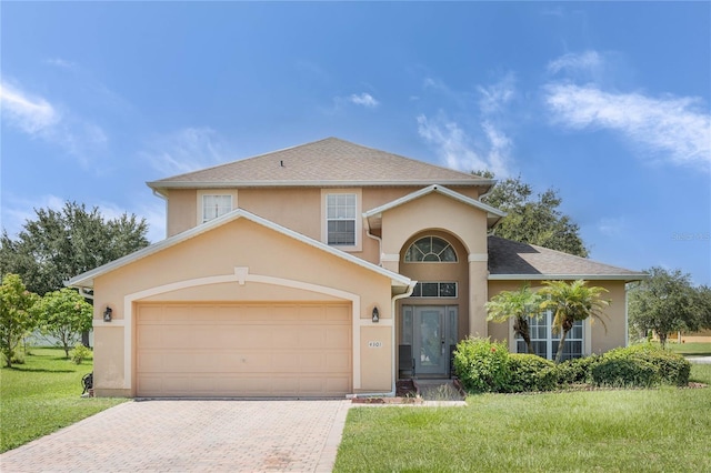 view of front of property featuring a front lawn and a garage