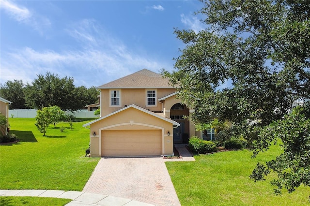 view of front of home featuring a front yard and a garage