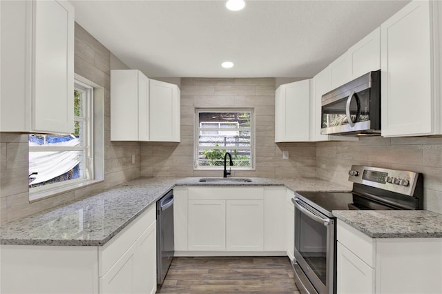 kitchen featuring appliances with stainless steel finishes, sink, and white cabinets