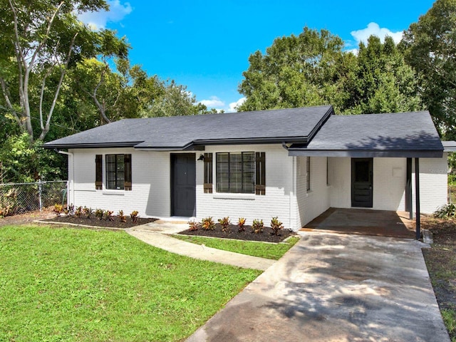 single story home with a front yard and a carport