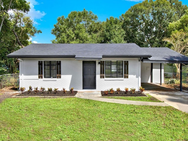 ranch-style home featuring a carport and a front yard