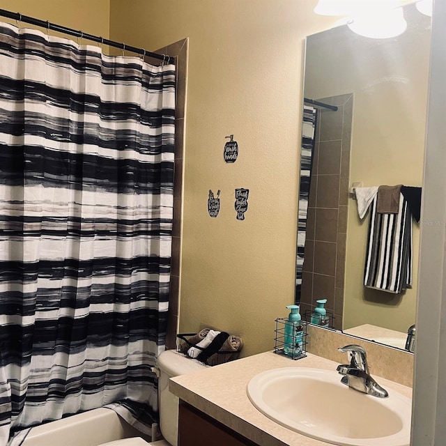 full bathroom with shower / bath combination with curtain, vanity, and toilet