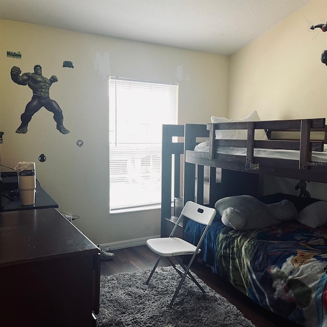 bedroom with dark wood-type flooring