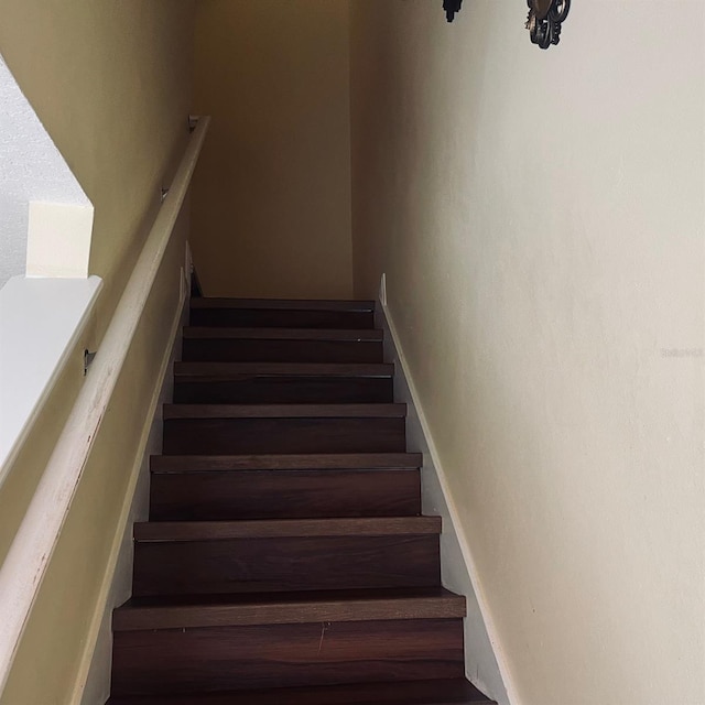 stairs featuring hardwood / wood-style floors