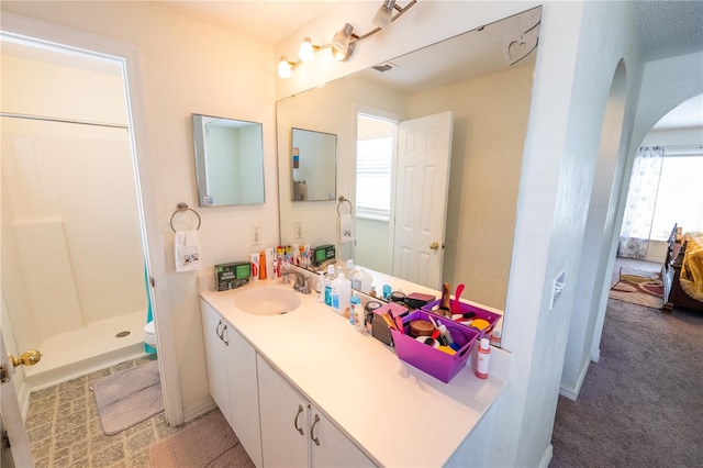 bathroom featuring vanity, toilet, and walk in shower