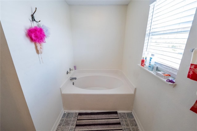 bathroom with a relaxing tiled tub