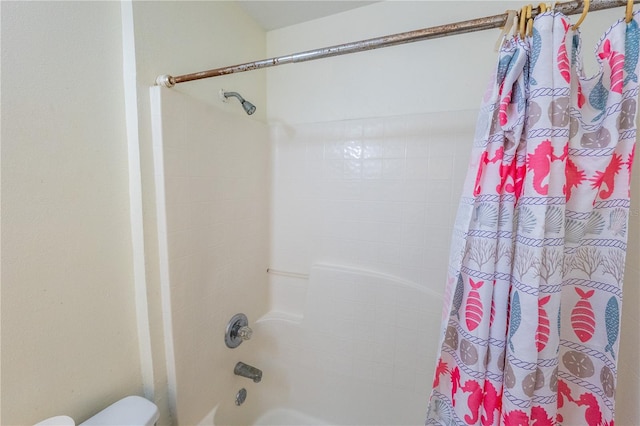 bathroom featuring toilet and shower / bathtub combination with curtain