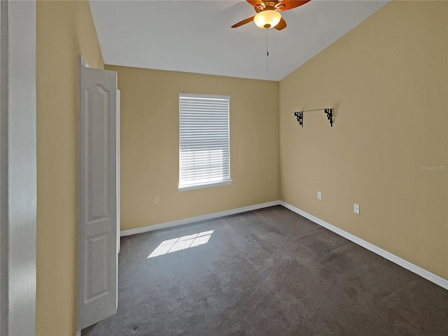 carpeted spare room with lofted ceiling and ceiling fan