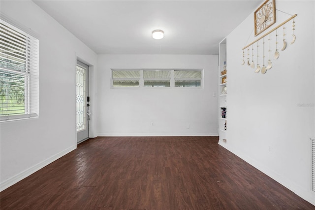 spare room featuring dark wood-type flooring