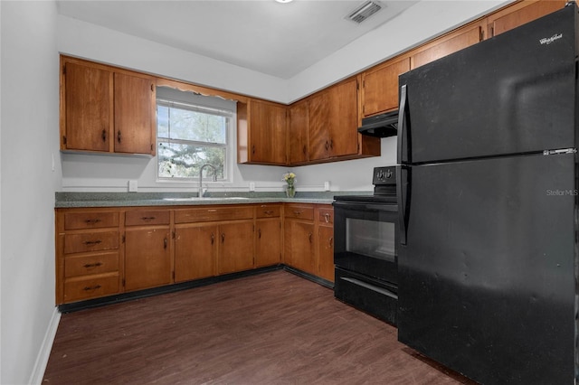 kitchen featuring dark hardwood / wood-style floors, black appliances, and sink