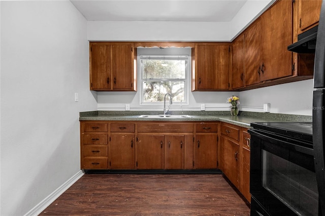 kitchen featuring sink, black / electric stove, and dark wood-type flooring