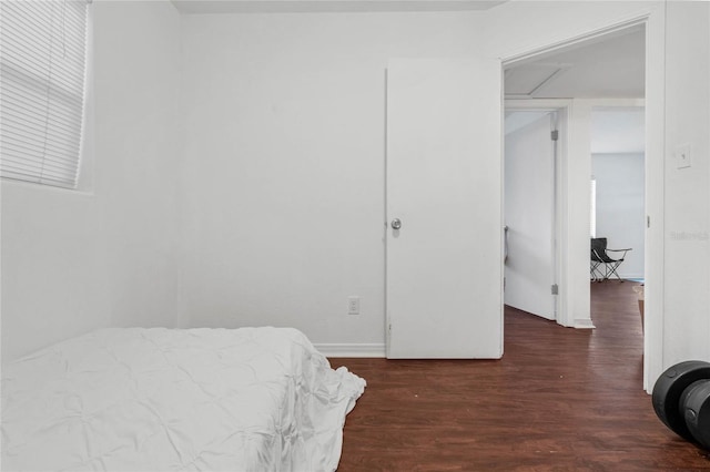 bedroom featuring a closet and dark hardwood / wood-style flooring