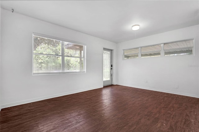 empty room with dark wood-type flooring