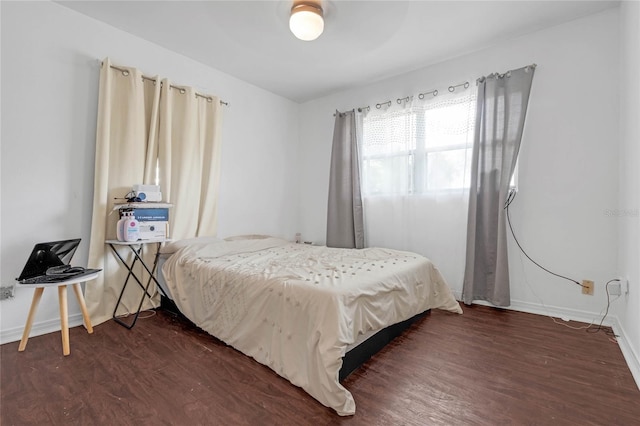 bedroom featuring ceiling fan and dark hardwood / wood-style floors