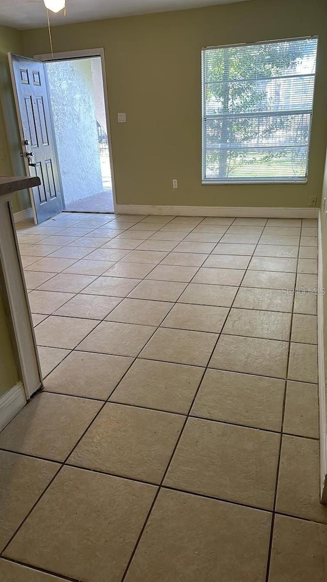 7622 Forest City Rd Unit E, Orlando, FL 32810 - empty room featuring light tile patterned floors and baseboards