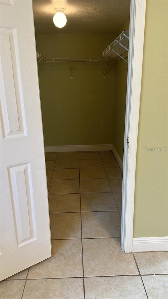 7622 Forest City Rd Unit E, Orlando, FL 32810 - spacious closet with light tile patterned floors