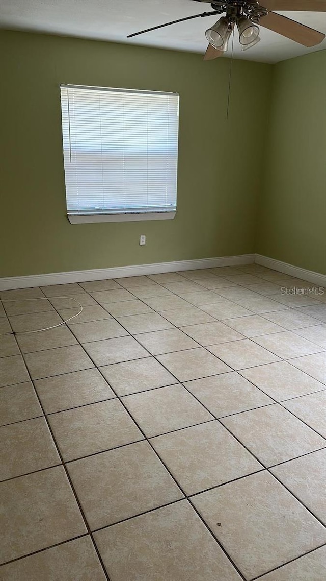 tiled empty room with ceiling fan