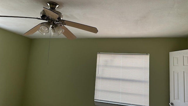 interior details featuring ceiling fan and a textured ceiling