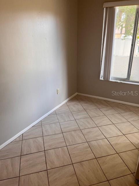 spare room featuring light tile patterned floors