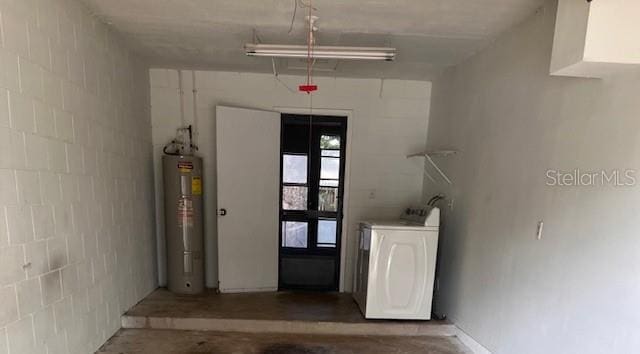 interior space with water heater and washer / dryer